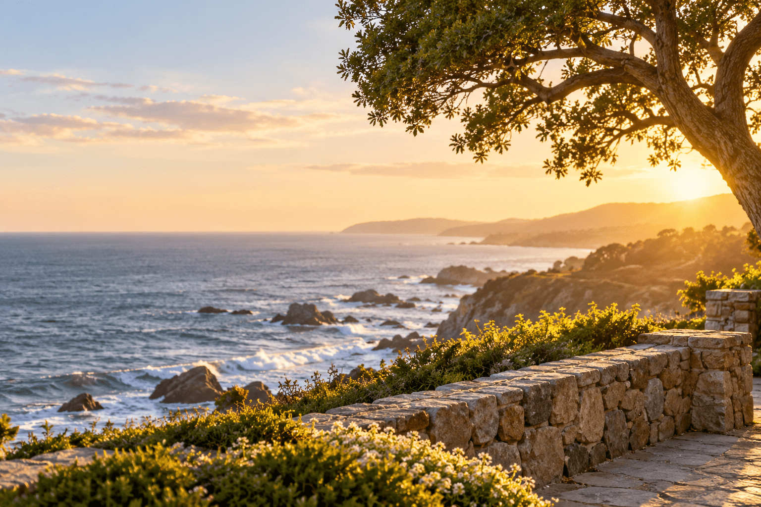 Stone wall along a coastal overlook at sunset, with waves breaking on the rocks below
